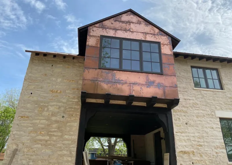 Copper metal panel facade on a stone building for Skylight Installation in Aledo